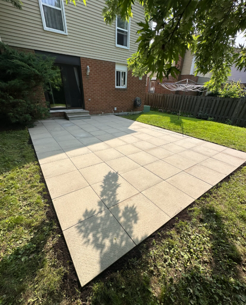 Patio after restoration — clean new large-format slabs perfectly level and finished