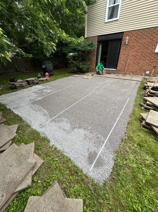Patio mid-restoration — base compacted and levelled, old slabs removed